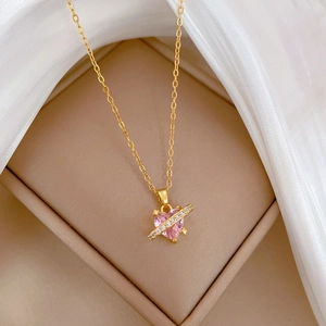 Elegant gold titanium necklace with pink heart gem and diamond bar in a jewelry box