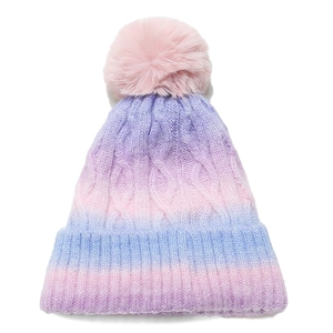 Close-up of cable knit texture and faux fur pom-pom on gradient colorful beanie