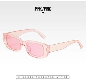 Detailed side view of vintage small rectangle pink sunglasses with transparent frames