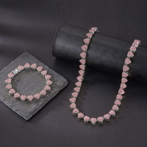 Macro shot of silver Cuban chain set with sparkling pink heart-shaped zircons