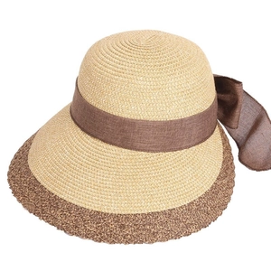 Women's woven straw sun hat with large brim and brown ribbon bow for beach vacation