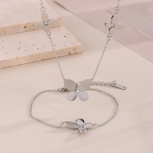 Detail of silver clover necklace and double-layer bracelet set with small crystals