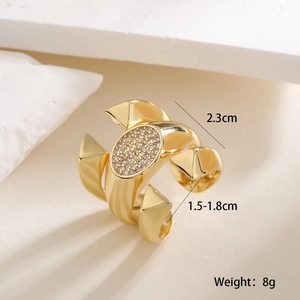 Detailed view of 18K gold plated ring with micro-paved rhinestones and pyramid studs