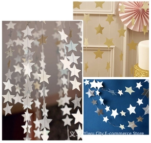 Close-up of glittery star and circle garland for gold and silver party decorations