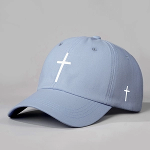 Detailed embroidery of white crosses on a light blue twill cotton baseball cap
