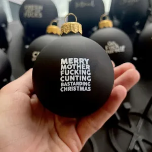 Funny black matte Christmas ornament with bold white offensive holiday greetings for trees