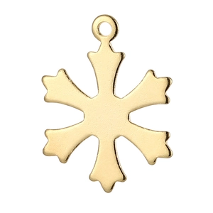 Macro view of gold stainless steel snowflake pendant with a polished metallic finish