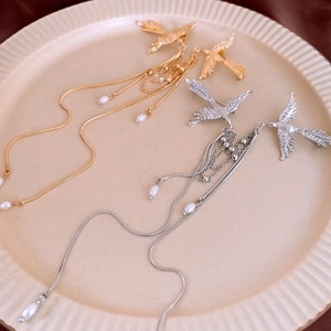 Elegant gold and silver phoenix bird brooches with pearls and long tassel chains