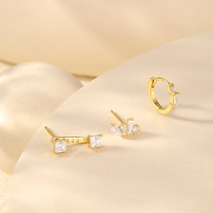 Macro shot of gold S925 silver earring set with sparkling cubic zirconia stones