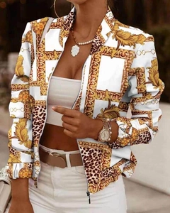 Detailed view of women's zip-up jacket with baroque and leopard gold patterns