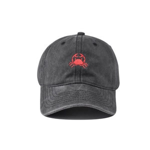 Detailed embroidery of a red crab on a washed vintage charcoal cotton baseball cap