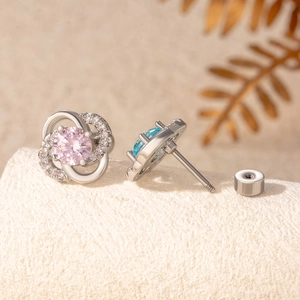 Silver clover stud earrings with pink and blue heart-and-arrow cubic zirconia stones