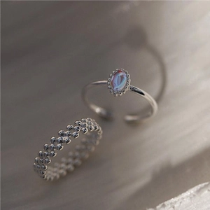 Macro view of 925 sterling silver bubble ring and oval iridescent gemstone ring