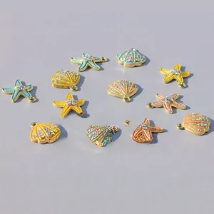 Close-up of colorful enamel starfish and seashell pendants with rhinestones for DIY jewelry