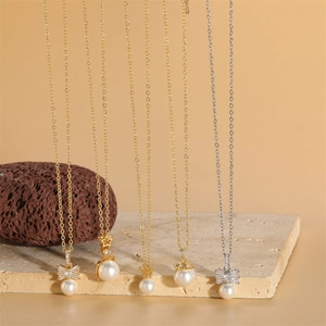 French vintage pearl and zircon pendant necklaces with bow and crown designs