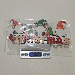 Detailed view of a wooden Christmas gnome sign on a scale showing its weight at 36.2g