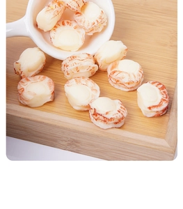 Macro shot of realistic PVC scallop meat miniatures on a wooden tray for DIY dollhouse play