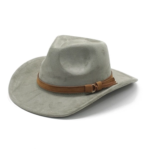 Detail of western fedora hat featuring brown leather band with gold buckle and fringe