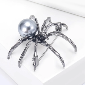 Detailed close-up of gunmetal spider brooch featuring a grey pearl body and black crystals