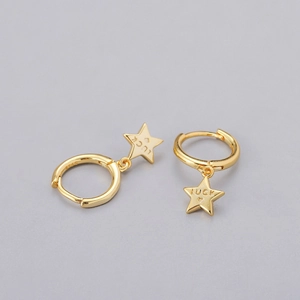 Close-up of gold star earrings with Luck engraving and S925 hallmark detail