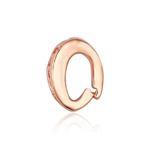 Macro shot of rose gold letter O jewelry pendant with high-polished mirror reflection