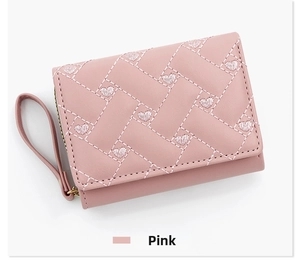 Close-up of pink trifold wallet with heart embroidery and quilted texture details