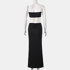 Detail of black backless crop top and slimming long skirt set on a mannequin display