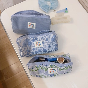 Three-piece ocean blue fabric storage bags with floral and corduroy patterns for stationery