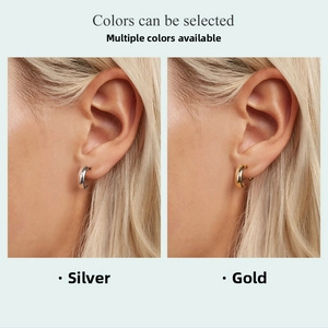 Minimalist C-shaped metal hoop earrings in silver and gold finishes on model
