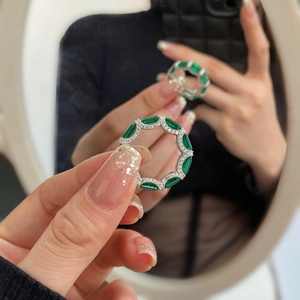 Macro shot of silver ring featuring emerald cut stones and micro-pave cubic zirconia