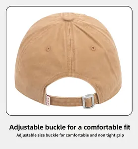 Detail of khaki cotton baseball cap showing adjustable silver buckle and X.C.Y logo tag