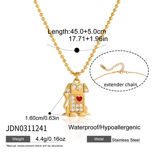 Detailed view of 18K gold plated stainless steel dog pendant with crystal and red heart