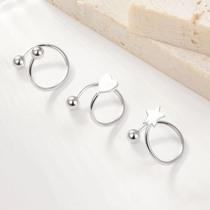 Detail of 925 sterling silver ball, heart, and star studs with polished metallic luster