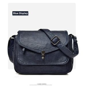 Detail view of the vintage dark blue soft leather crossbody bag with metal flip lock