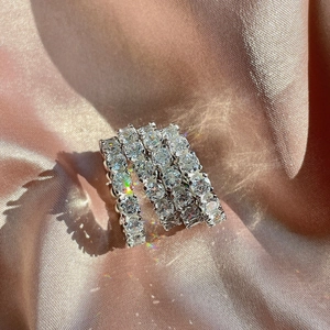 Macro detail of S925 sterling silver ring featuring full 5A zircon pavé setting on pink satin