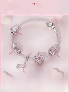 Detail of S925 silver charm bracelet with pink heart zircon and Forever Family engraving