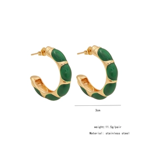 Detailed view of vintage gold-plated stainless steel C-shape earrings with green enamel