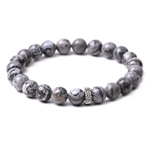 Detailed view of gray marble stones and a silver textured spacer bead on a stretch bracelet
