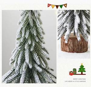 Close-up of snow-covered mini Christmas tree with a natural wooden base for desk