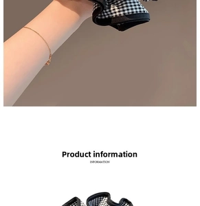Détail d'un chouchou géant à carreaux noir et blanc en tissu doux et plissé