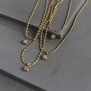 Minimalist gold titanium steel necklace featuring a round white aventurine pendant