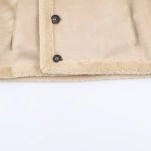 Detail of beige faux suede jacket showing soft sherpa trim and dark resin buttons