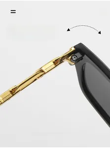Close-up of durable golden metal hinges on narrow cat-eye sunglasses with black frames