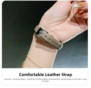 Detail of taupe leather watch strap with white stitching and silver metal buckle