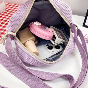 Purple corduroy crossbody bag interior showing spacious storage for daily items