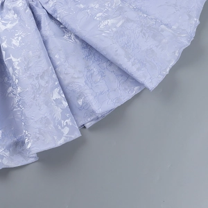 Macro shot of light purple floral jacquard fabric with elegant embossed textures