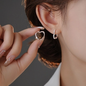 Minimalist silver heart-shaped hoop earrings with irregular texture for a stylish look