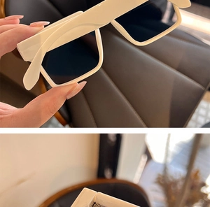 Detail of trendy punk square sunglasses with cream white frame and wide temples
