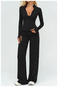 Detail of black sports set with thumb-hole sleeves and loose straight-leg pants
