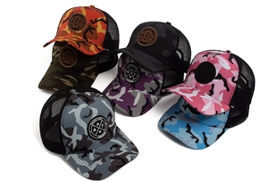 Detailed view of colorful camouflage mesh baseball caps with Enjoy Life circular patches